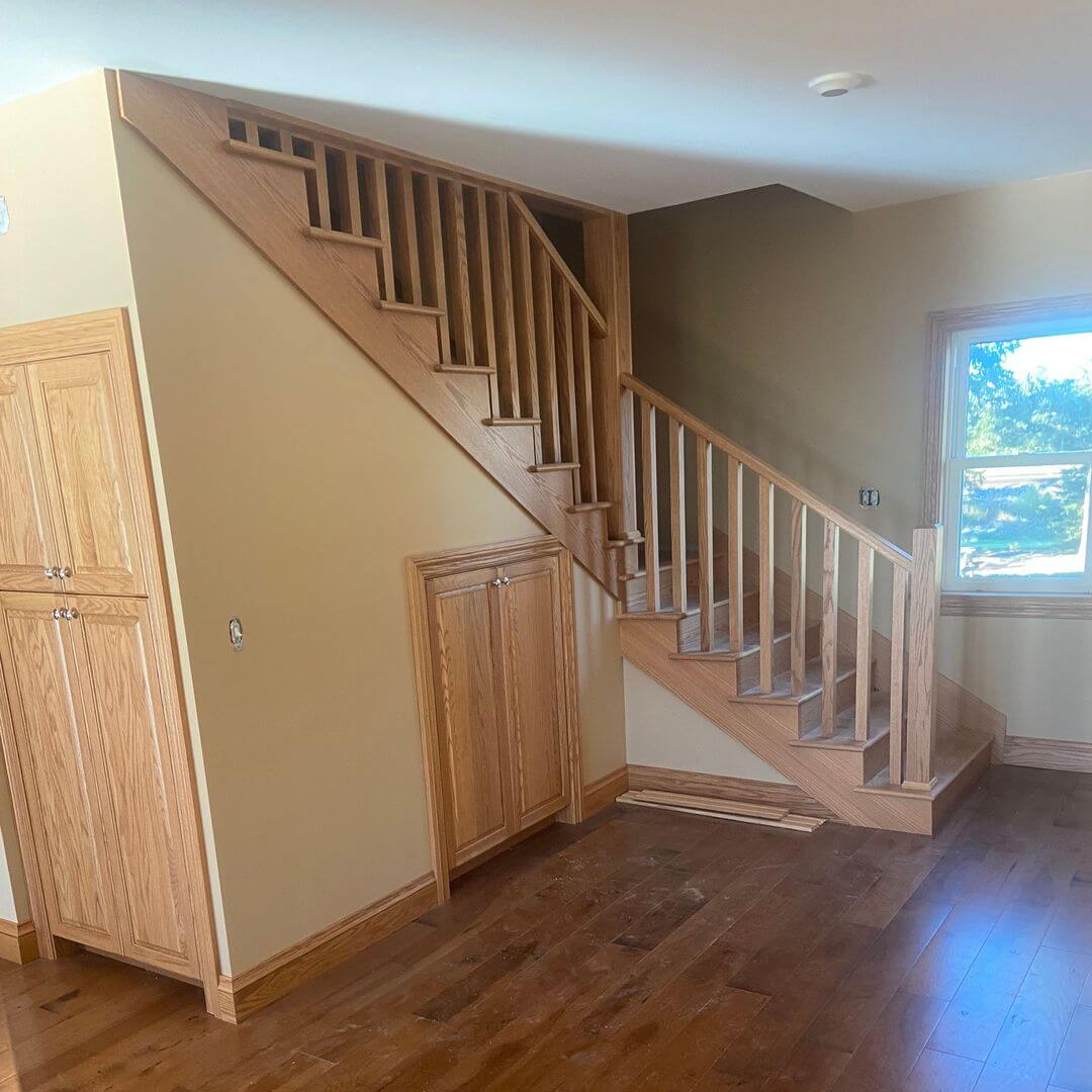 Zoeller Bros. wooden staircase, railing, built-in cupboards and architectural trim